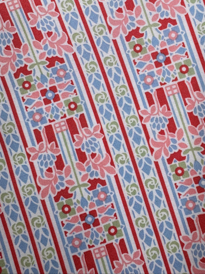 Patterned fabric with red, blue, and green stripes on a wooden surface
