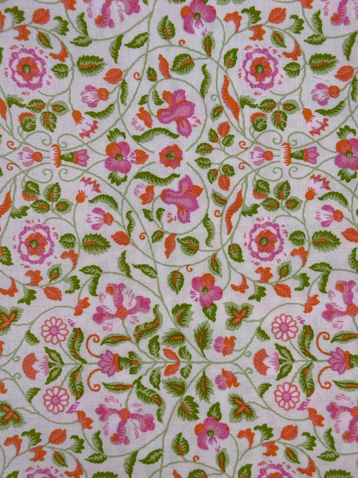 Floral patterned fabric with pink, green, and orange flowers on a white background