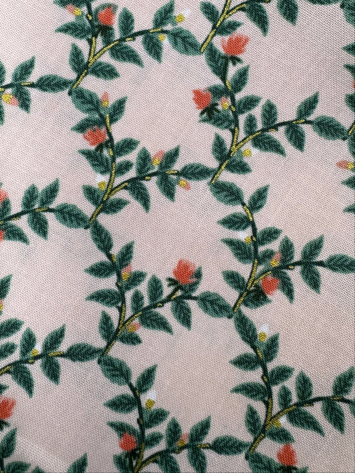 Fabric with leaf pattern on a wooden surface